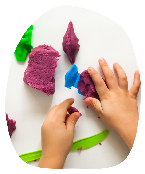 small hands playing with play dough