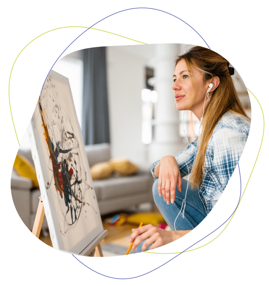 woman doing art therapy while listening to music